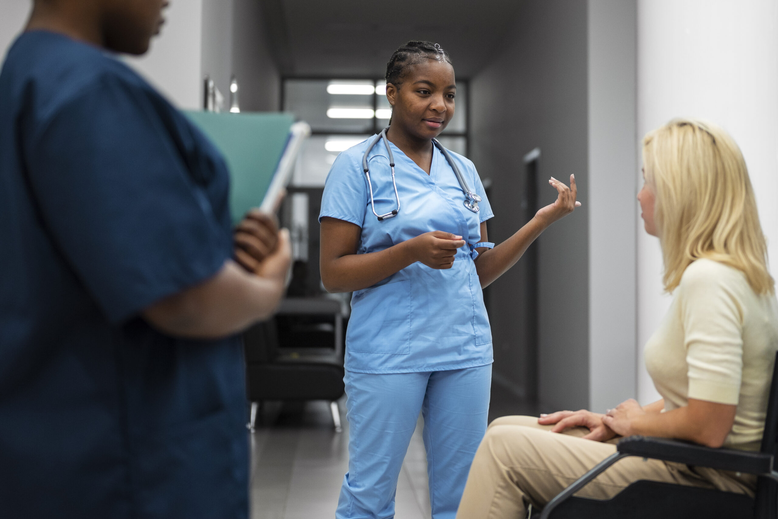 side-view-nurses-talking-patient